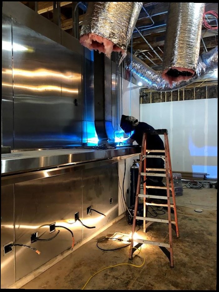 Technician brazing HVAC ductwork connections